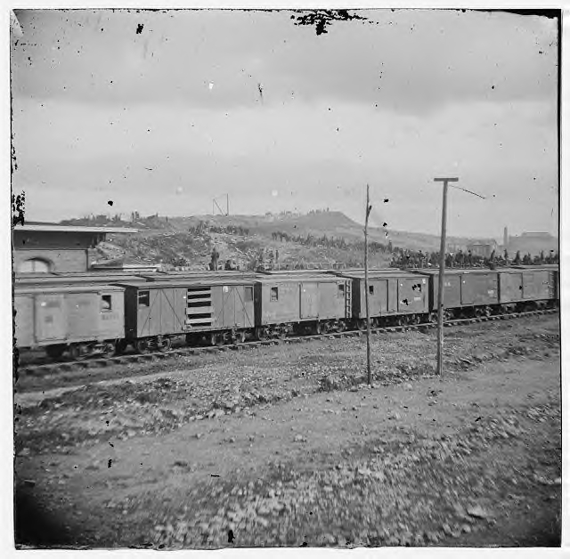Box cars. Notice the ventilation "windows" and the car with its door missing.
