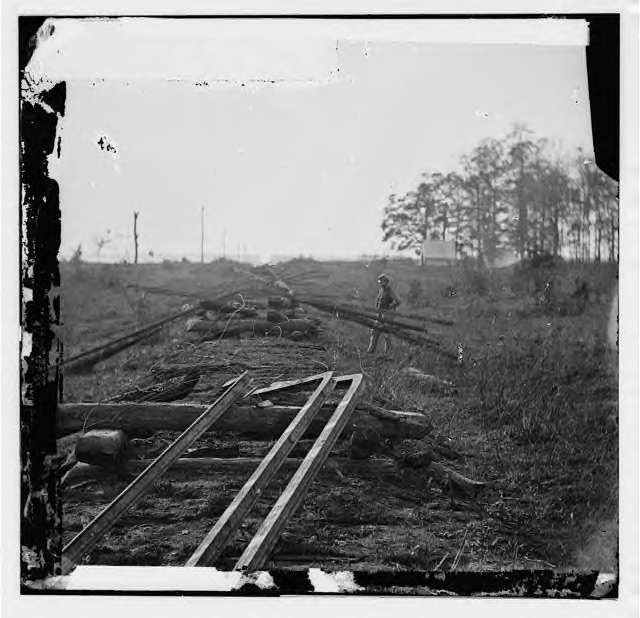 Track destroyed by retreating Confederates on the Orange & Alexandria RR in the spring of 1862. The picture is down the road bed. The rails were bent around a post. There appears to have been no burning of ties or heating of rails here.