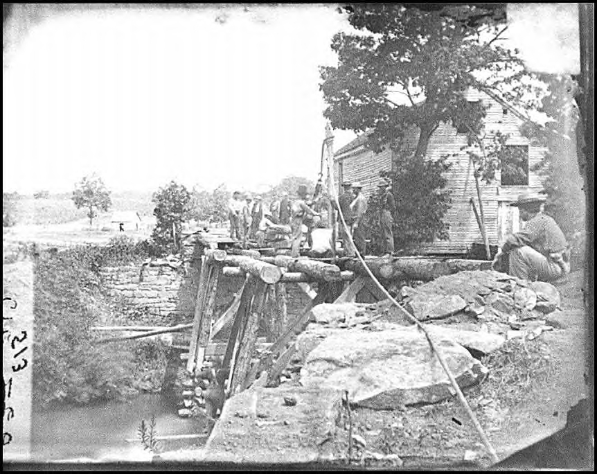 Repair work in progress on a bridge of about 50 feet in length.